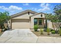 Charming single-story home with a two-car garage, desert landscaping and a light stucco finish at 5956 N 188Th Ln, Litchfield Park, AZ 85340
