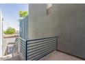 View from a balcony showing the building's exterior with blue railings and stucco walls at 615 E Portland St # 261, Phoenix, AZ 85004