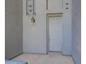 The front door is a modern gray with unit number 261, lit by a coach lamp at 615 E Portland St # 261, Phoenix, AZ 85004