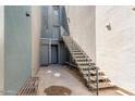 Exterior staircase leading to upper-level units, with metal railings and multiple entry doors below at 615 E Portland St # 261, Phoenix, AZ 85004