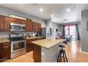 Well-equipped kitchen with granite countertops, stainless steel appliances, and an adjacent dining area at 6328 W Fawn Dr, Laveen, AZ 85339