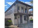 Inviting two-story residence featuring a charming balcony, well-kept grounds, and stylish design elements at 6908 S 8Th Dr, Phoenix, AZ 85041