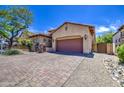 Charming single-story home featuring a tile roof, large driveway, and mature landscaping at 6941 E Snowdon St, Mesa, AZ 85207