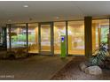 The building entrance features glass doors, greenery, and a modern, inviting aesthetic at 7157 E Rancho Vista Dr # 1004, Scottsdale, AZ 85251