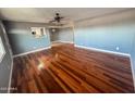 Open living room features wood floors and a view into the bright kitchen at 7903 N 61St Ave, Glendale, AZ 85301