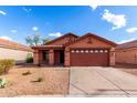 Well-maintained single-story home featuring desert landscaping, a two-car garage, and a charming, welcoming front exterior at 8433 E Natal Cir, Mesa, AZ 85209