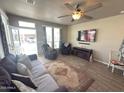 Comfortable living room with tile floors, ceiling fan, and large windows providing natural light at 8865 E Baseline Rd # 614, Mesa, AZ 85209