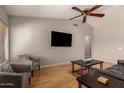 Spacious living room with a ceiling fan, hardwood floors and comfortable chairs at 901 N Quartz St, Gilbert, AZ 85234