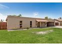 A bright single-story brick home featuring well-kept lawn and a tiled awning over the entrance at 908 S Kachina --, Mesa, AZ 85204