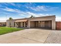 Charming single-story brick home with a covered parking area and a well-maintained driveway at 908 S Kachina --, Mesa, AZ 85204