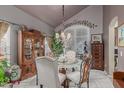 Formal dining room with decorative furniture, ornate chandelier, and large windows at 991 N Quail Ln, Gilbert, AZ 85233