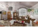 Inviting living room featuring vaulted ceilings, a chandelier, and an abundance of natural light at 991 N Quail Ln, Gilbert, AZ 85233