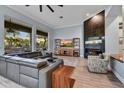 Modern living room featuring hardwood floors, a sleek fireplace, and large windows with scenic views at 10694 E Redfield Rd, Scottsdale, AZ 85255