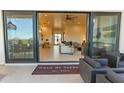 Open floor plan showcases a beautifully designed living room with seamless indoor-outdoor transition to the patio at 10918 W Dove Roost Rd, Queen Creek, AZ 85144