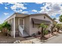 Corner lot featuring a white stairway leading to the front door and mature landscaping along the side of the home at 11596 W Sierra Dawn Blvd # 271, Surprise, AZ 85378