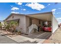 Side view showing a covered parking area, stairs leading up to the side door and mature landscaping at 11596 W Sierra Dawn Blvd # 271, Surprise, AZ 85378