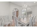 Open dining room with wood floors, chandelier, with views to office and front entrance at 1207 E Clearview Dr, Casa Grande, AZ 85122
