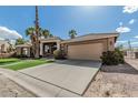 Garage and entrance to a home with a desert landscaped yard on a clear, sunny day at 1207 E Clearview Dr, Casa Grande, AZ 85122