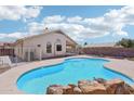 Backyard pool featuring a rock surround, blue water, and a diving platform at 12626 W Windsor Ave, Avondale, AZ 85392