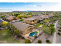 Beautiful property featuring a luxurious backyard pool and spa, surrounded by a serene neighborhood setting at 12702 W Dove Wing Way, Peoria, AZ 85383