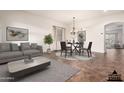 Staged living and dining area with stylish furniture and decor creates a welcoming atmosphere at 12702 W Dove Wing Way, Peoria, AZ 85383