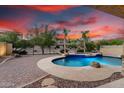 Stunning pool with natural stone accents, built in spa, and lush landscaping at 12702 W Dove Wing Way, Peoria, AZ 85383