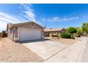 A wide shot of the front of an exterior elevation with a two-car garage and an American flag at 15047 W Kings Dr, Surprise, AZ 85374