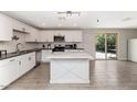 Modern kitchen featuring an island, stainless steel appliances, and crisp white cabinets, great for entertaining at 15049 N 25Th Pl, Phoenix, AZ 85032