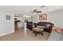 Inviting living room showcases a spacious layout and transitions into an open-concept kitchen area with wood flooring at 15049 N 25Th Pl, Phoenix, AZ 85032