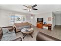 Comfortable living room boasts ample natural light, ceiling fan, and wood flooring perfect for relaxation at 15049 N 25Th Pl, Phoenix, AZ 85032
