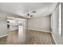 Spacious living room featuring wood flooring and a seamless flow into the bright, modern kitchen at 15049 N 25Th Pl, Phoenix, AZ 85032