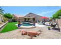 This backyard offers a pool, patio, and swing, perfect for entertaining and relaxing outdoors at 17710 W Buena Vista Dr, Surprise, AZ 85374