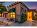 Attractive home exterior with a well-manicured yard, sidewalk lighting, and a three-car garage at 17710 W Buena Vista Dr, Surprise, AZ 85374
