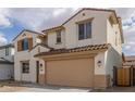 Inviting two-story home showcasing desert landscaping, a two-car garage, and a charming facade with shuttered windows at 18383 W Monte Lindo Ln, Surprise, AZ 85387
