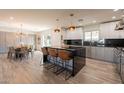 Gourmet kitchen with stainless steel appliances, waterfall island and dining space at 1911 E Claremont St, Phoenix, AZ 85016