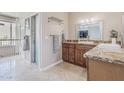 Bright bathroom with a modern vanity, granite countertops, and a glass enclosed shower at 2254 E Becker Ln, Phoenix, AZ 85028