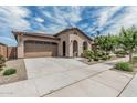 Lovely desert home featuring a two-car garage, mature landscaping, and charming curb appeal at 23068 E Stacey Rd, Queen Creek, AZ 85142