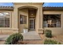 Charming home featuring a welcoming front entrance with an arched doorway, providing curb appeal at 23705 S Pleasant Way, Sun Lakes, AZ 85248