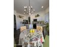 Bright kitchen featuring a charming breakfast nook with a chandelier, creating a cozy dining space at 23705 S Pleasant Way, Sun Lakes, AZ 85248
