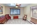 Cozy living room with classic furniture, neutral walls, ceiling fan and soft carpeting creating a relaxing ambiance at 2424 E Ivy St, Mesa, AZ 85213