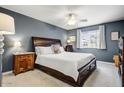 Comfortable bedroom with a ceiling fan, nightstands and soft carpet at 2846 E Lupine Ave, Phoenix, AZ 85028