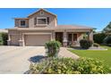 Inviting two-story home with a three-car garage, covered front porch, and colorful flowers at 2886 E Hazeltine Way, Chandler, AZ 85249