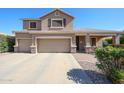 Inviting two-story home with a three-car garage, covered front porch, and landscaped yard at 2886 E Hazeltine Way, Chandler, AZ 85249