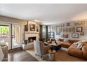 Relaxing living room showcases a cozy fireplace, hardwood floors, and stylish furniture at 2941 E Nisbet Ct, Phoenix, AZ 85032