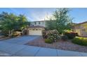 Charming home featuring mature trees and landscaping, a two-car garage, and an inviting facade at 29740 N 121St Ave, Peoria, AZ 85383