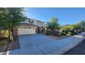 Inviting home with manicured lawn, mature trees, and a two-car garage at 29740 N 121St Ave, Peoria, AZ 85383