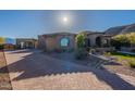 Stunning single-story home boasts a grand arched entryway, manicured landscaping, and a spacious brick driveway at 3118 W Glenhaven Dr, Phoenix, AZ 85045