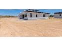 The back exterior of this home has a white facade, black trim and large lot at 3335 W Desert Dawn Dr, Phoenix, AZ 85083