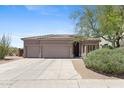 Charming home exterior featuring a well-maintained front yard and attached three-car garage at 3544 N Paseo Del Sol --, Mesa, AZ 85207