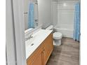 Bathroom featuring new flooring, a tub with shower, and a modern vanity at 3810 N Maryvale Pkwy # 1070, Phoenix, AZ 85031